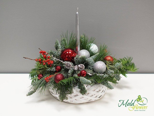 Composition with silver candle, cones, decorative rowan trees, Christmas toys, spruce branches photo