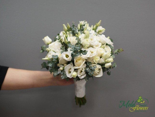 Bridal bouquet of white roses, eustoma, and eucalyptus photo