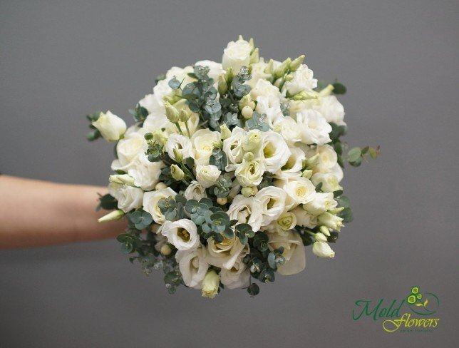 Bridal bouquet of white roses, eustoma, and eucalyptus photo