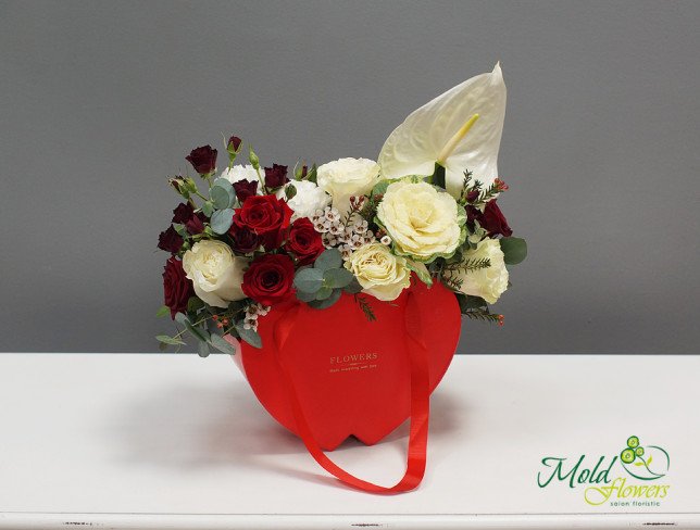 Composition with red roses, white anthuriums, and cream roses, decorated with greenery, arranged in a red box