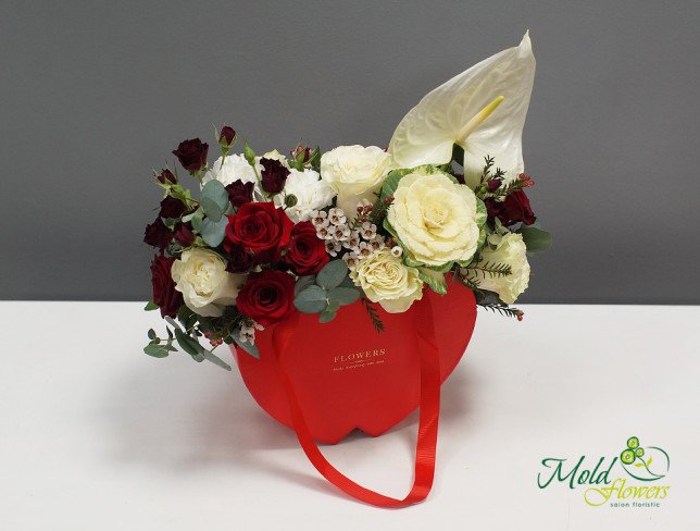 Composition with red roses, white anthuriums, and cream roses, decorated with greenery, arranged in a red box