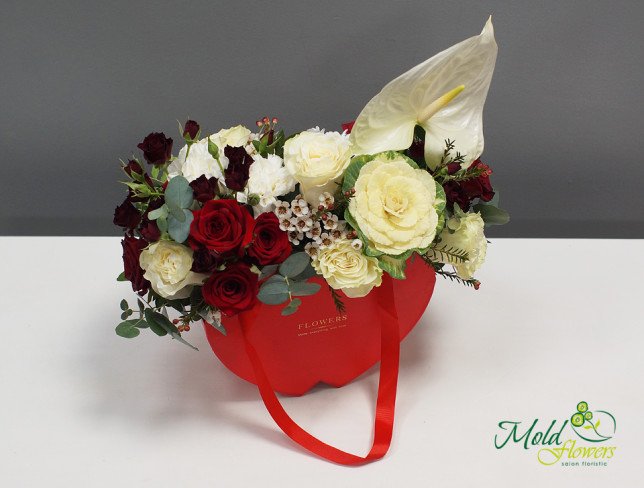 Composition with red roses, white anthuriums, and cream roses, decorated with greenery, arranged in a red box