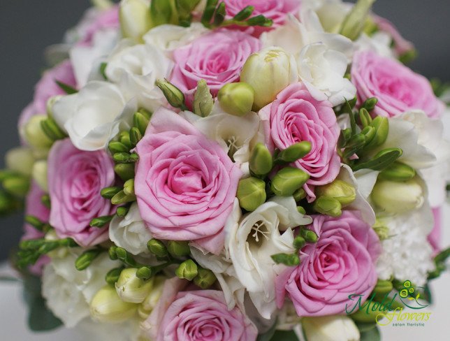 Bridal bouquet of pink roses, lisianthus, and white freesia photo
