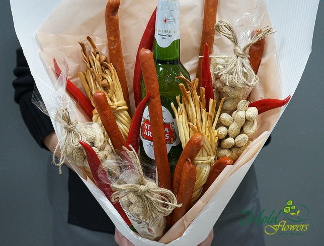 Bouquet with red and green peppers, pigtail cheese, peanuts, beer bottle, sausage in kraft paper photo