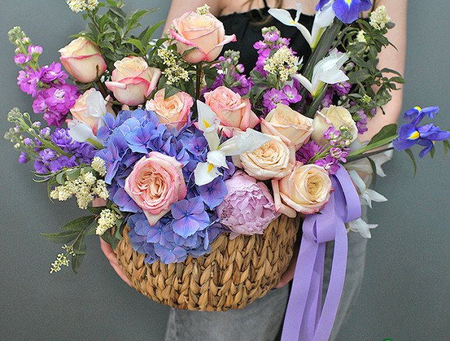 Wicker basket with purple hydrangea and roses photo