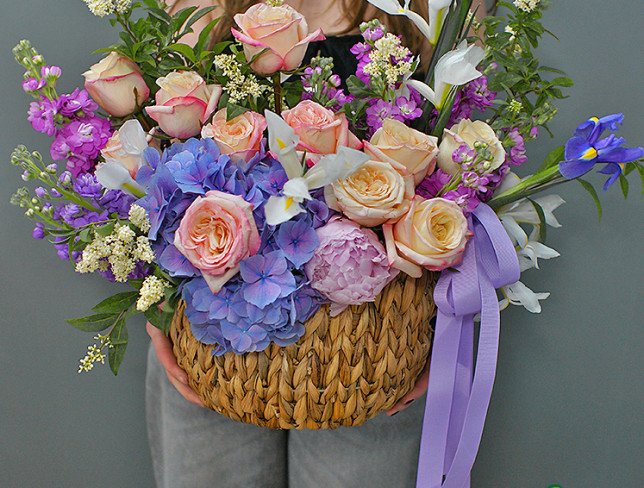 Wicker basket with purple hydrangea and roses photo