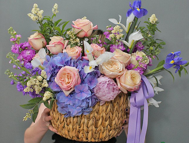 Wicker basket with purple hydrangea and roses photo