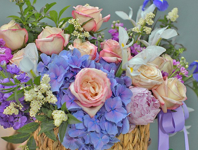 Wicker basket with purple hydrangea and roses photo