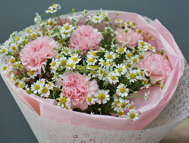 Bouquet of pink carnations and chamomile photo