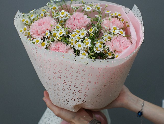 Bouquet of pink carnations and chamomile photo