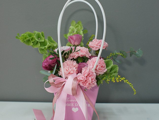 Handbag with pink carnations and eustomas photo