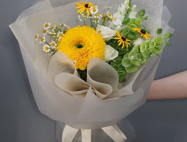 Bouquet of white roses, sunflowers and chamomile photo