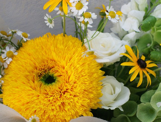 Bouquet of white roses, sunflowers and chamomile photo