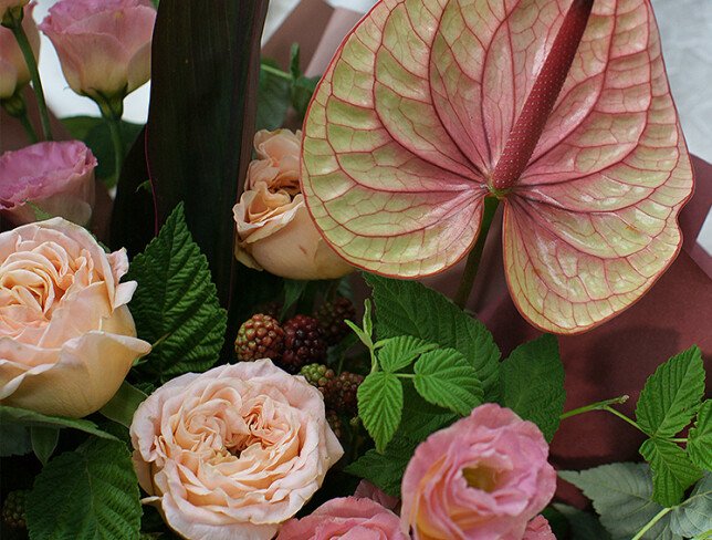 Bouquet of anthurium and raspberry branches 