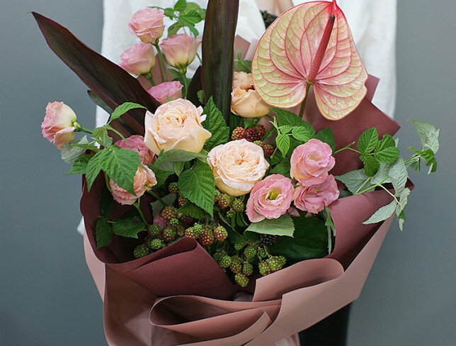 Bouquet of anthurium and raspberry branches 