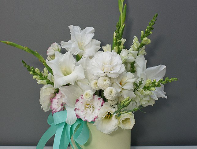 Box with white gladioli and eustoma photo