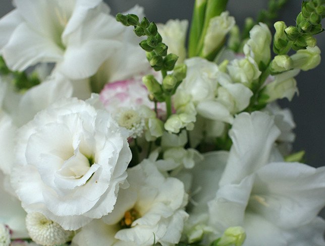 Box with white gladioli and eustoma photo