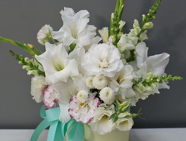 Box with white gladioli and eustoma photo