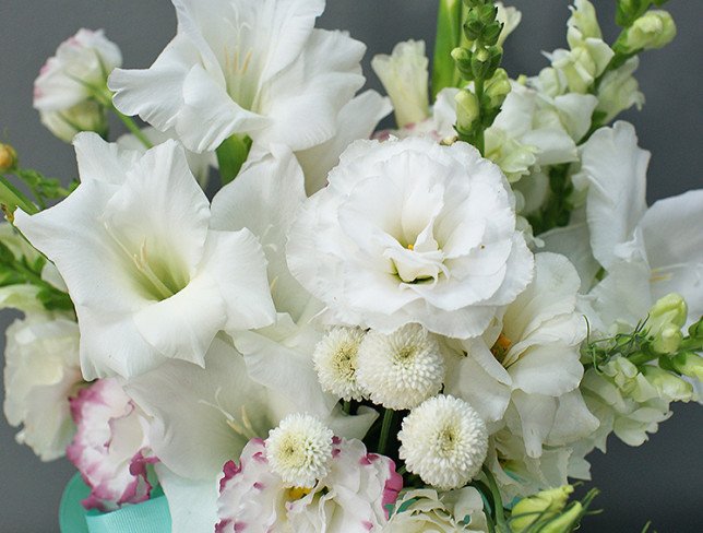 Box with white gladioli and eustoma photo