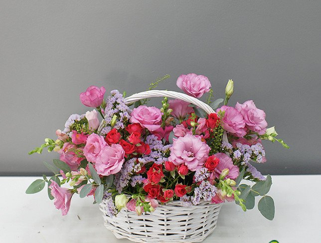 Basket with pink eustoma and roses photo