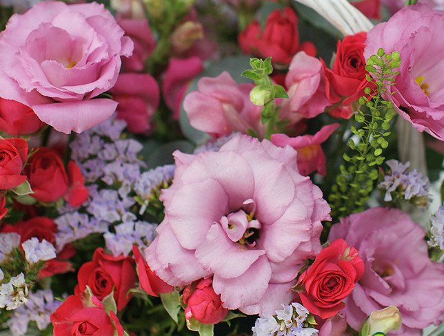 Basket with pink eustoma and roses photo