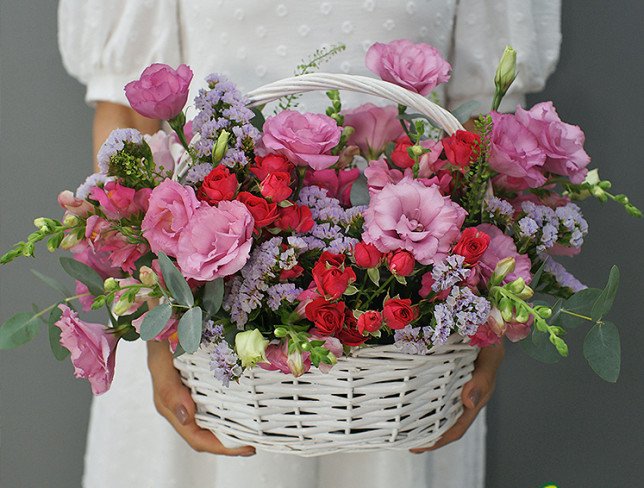 Basket with pink eustoma and roses photo