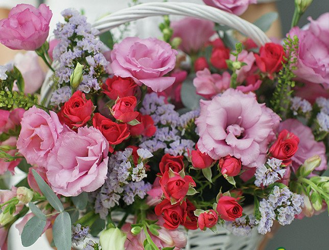 Basket with pink eustoma and roses photo