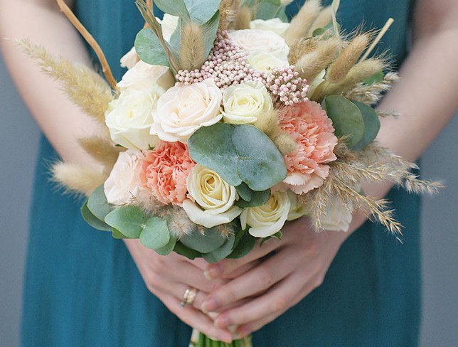 Bridal bouquet of white roses, carnations, ozotamnus and eucalyptus photo