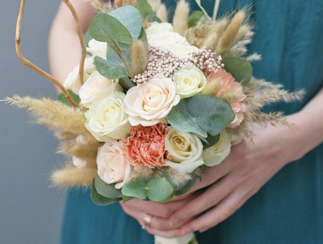 Bridal bouquet of white roses, carnations, ozotamnus and eucalyptus photo