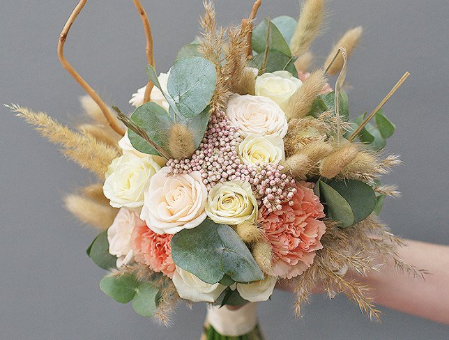 Bridal bouquet of white roses, carnations, ozotamnus and eucalyptus photo