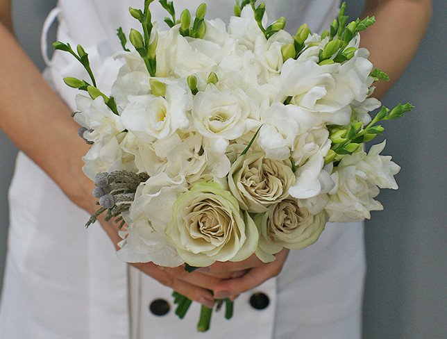 Bridal bouquet of green roses, hydrangea, freesia and carnations photo