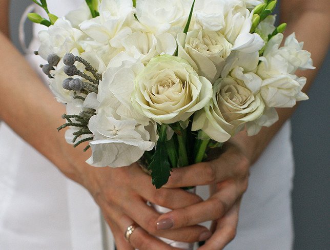 Bridal bouquet of green roses, hydrangea, freesia and carnations photo