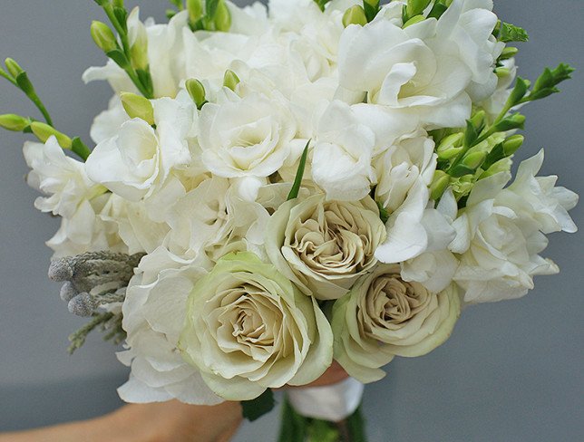 Bridal bouquet of green roses, hydrangea, freesia and carnations photo