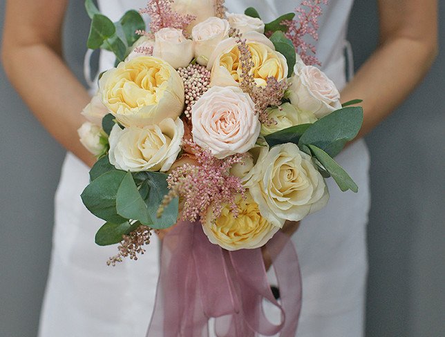 Bridal bouquet of cream roses, carnations, astilbe and eucalyptus photo