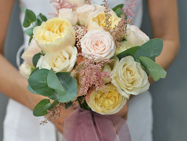 Bridal bouquet of cream roses, carnations, astilbe and eucalyptus photo