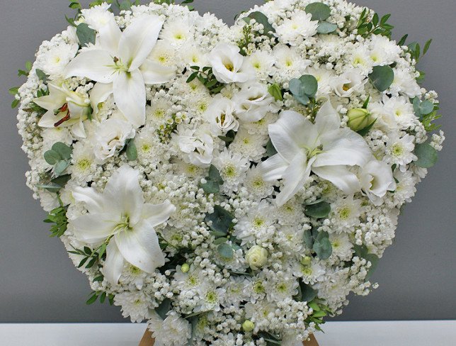 Heart of white chrysanthemums and lilies on a stand photo