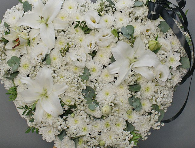 Heart of white chrysanthemums and lilies on a stand photo