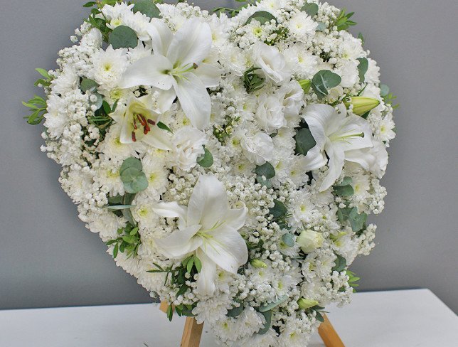 Heart of white chrysanthemums and lilies on a stand photo