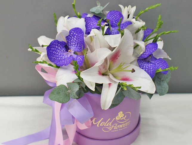 Box with lilies and vanda orchid photo