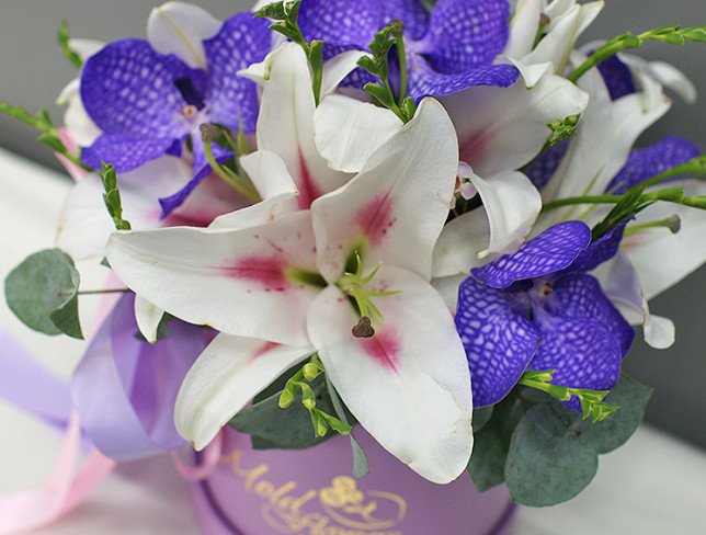 Box with lilies and vanda orchid photo