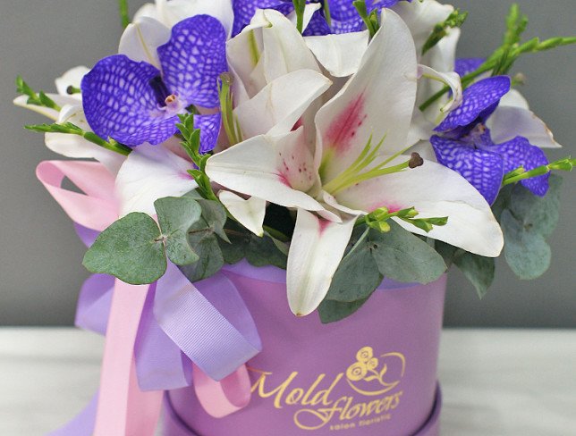 Box with lilies and vanda orchid photo