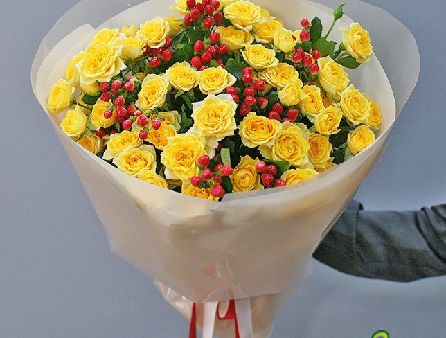 Bouquet of yellow bush roses and hypericum "Heart of the Sun" photo