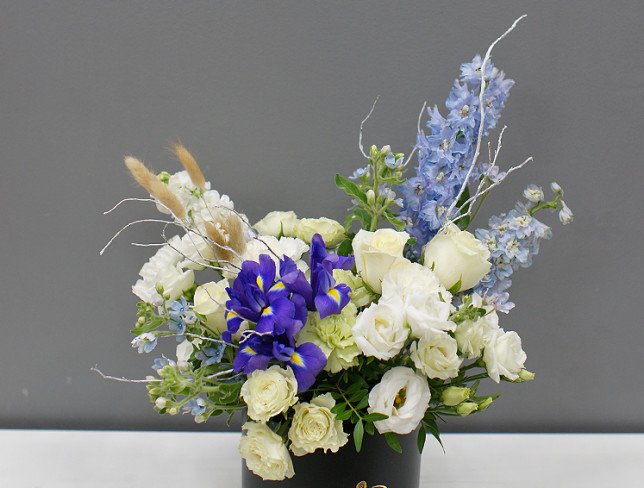 Box with white roses and delphinium photo