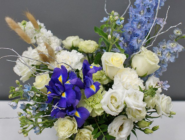 Box with white roses and delphinium photo