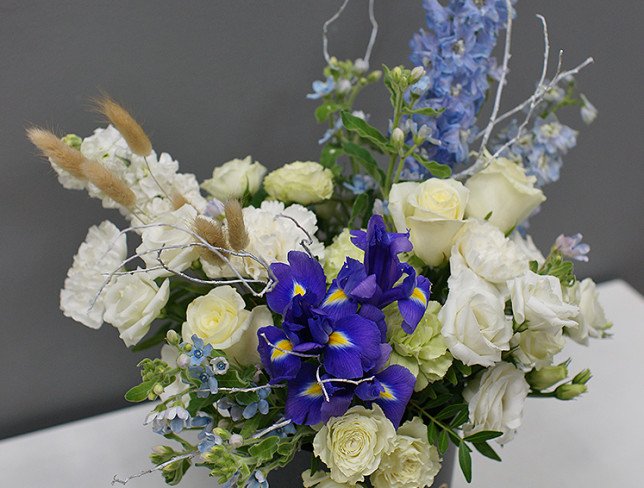 Box with white roses and delphinium photo