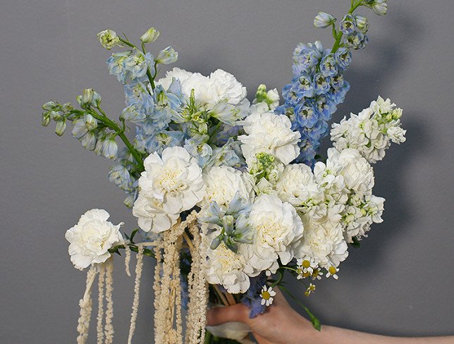 Bouquet of white carnations and blue delphinium photo