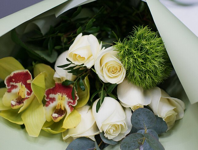 Bouquet of white roses, orchids and fluffy green dianthus photo