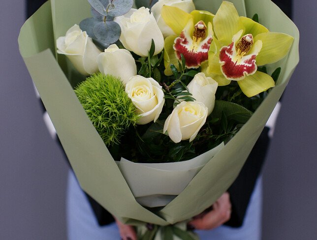 Bouquet of white roses, orchids and fluffy green dianthus photo