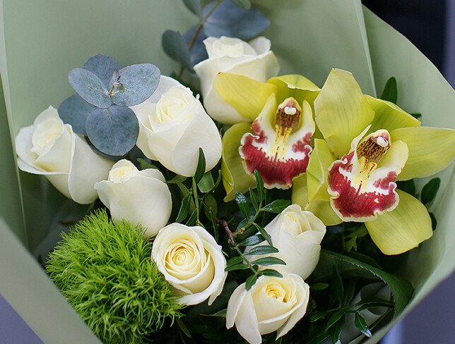 Bouquet of white roses, orchids and fluffy green dianthus photo