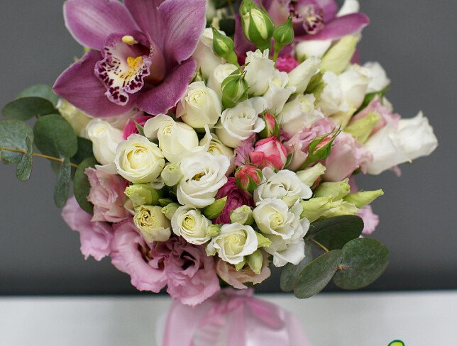 Bridal bouquet of eustome, bush roses and pink orchids photo